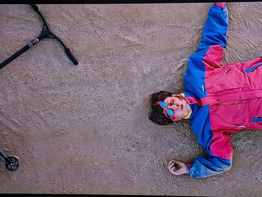 Oliver Tree in colorful tracksuit by a scooter