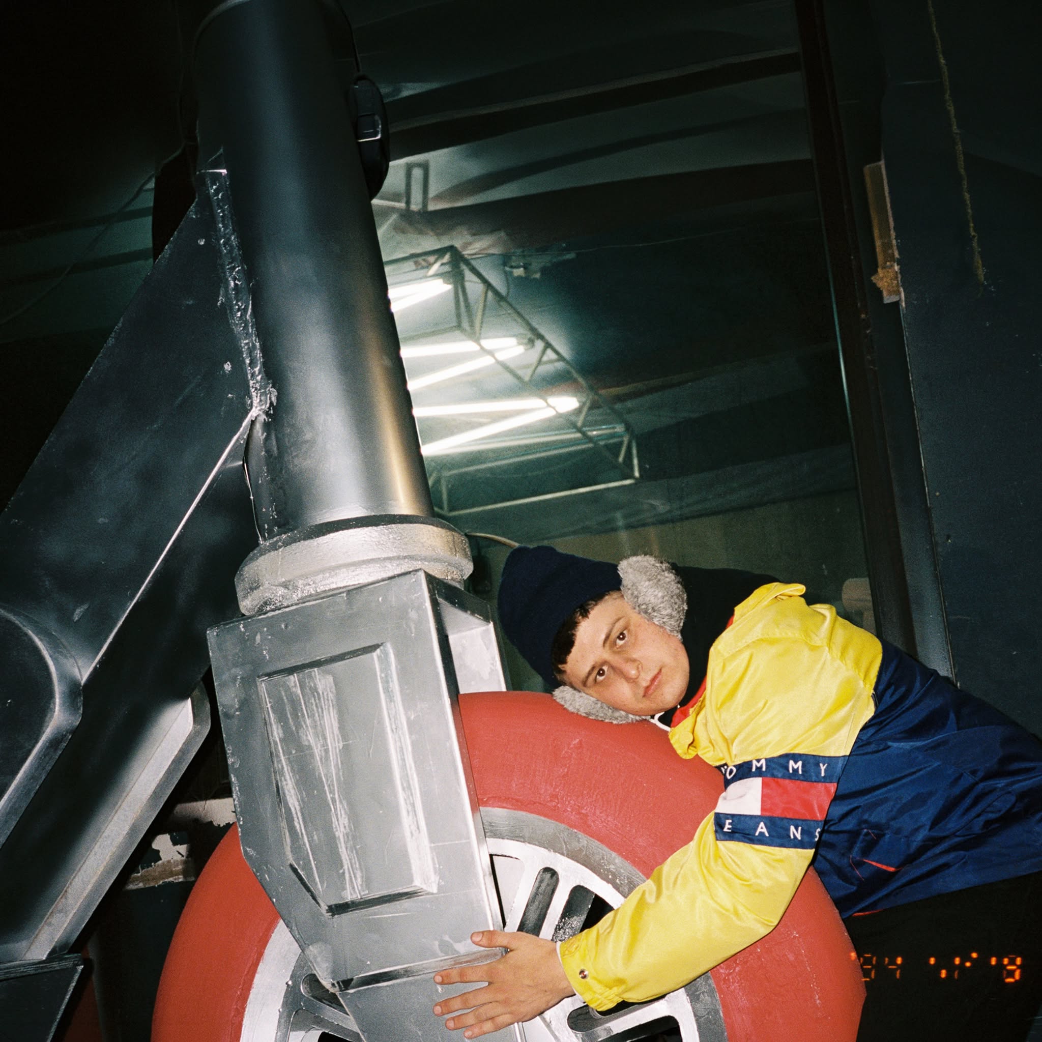 Oliver Tree hugging a large scooter prop at night